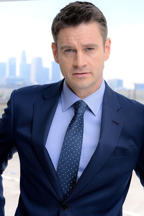 Clark Moore — formal headshot, blue suit