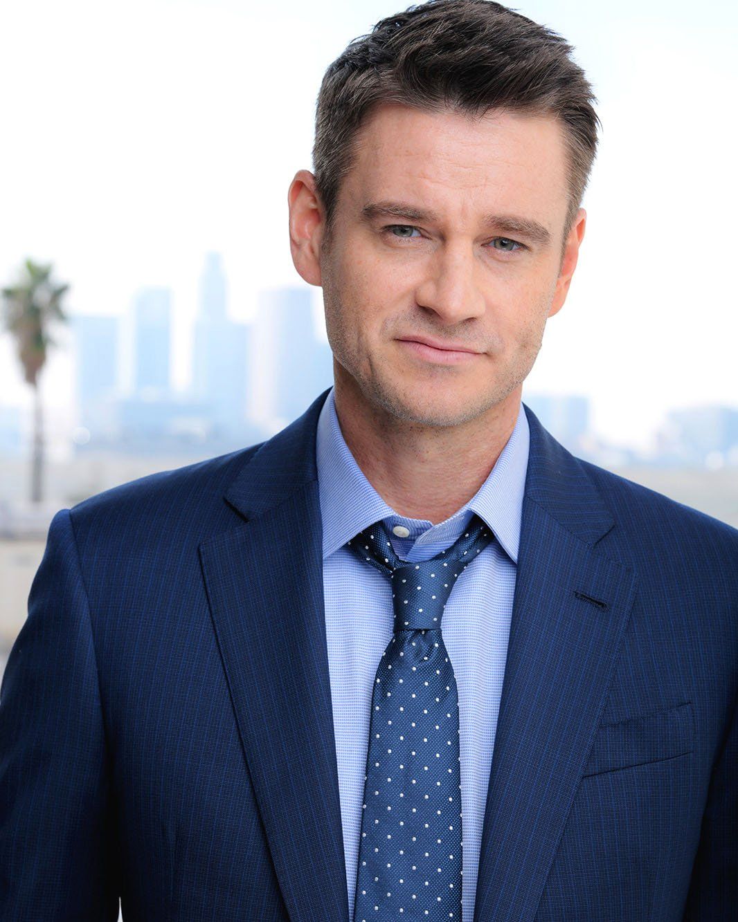 Clark Moore — headshot, blue suit